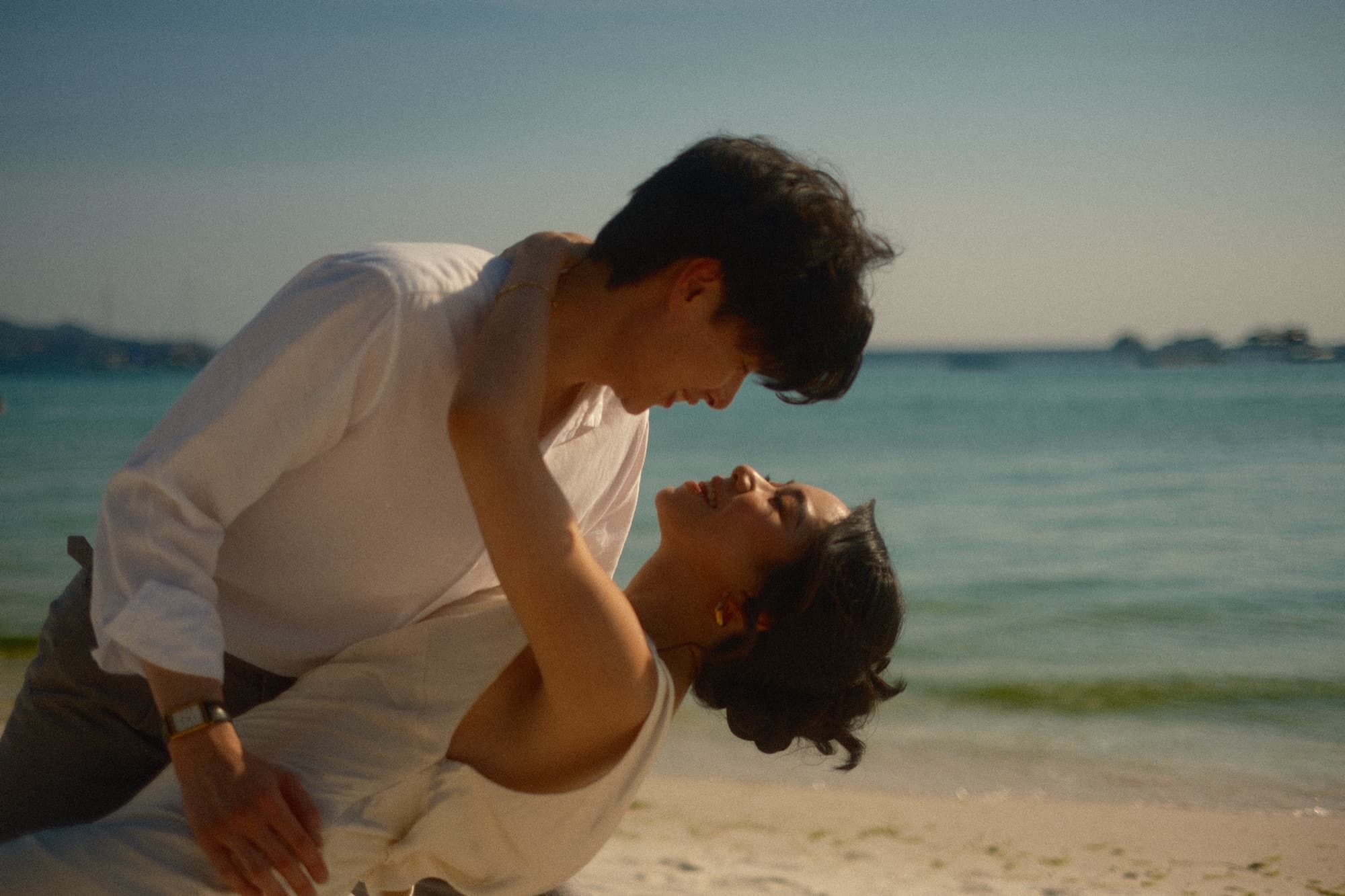 Couple embracing on the beach at golden hour